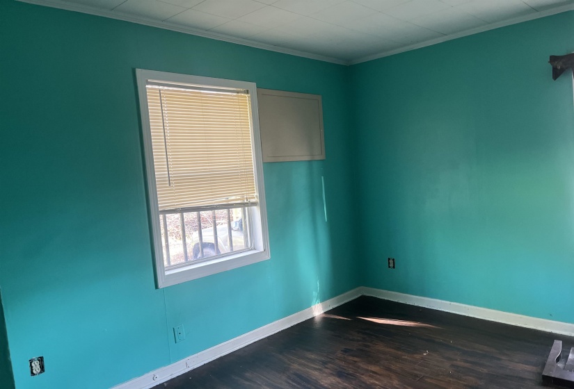 Empty room with baseboards, ornamental molding, and wood finished floors