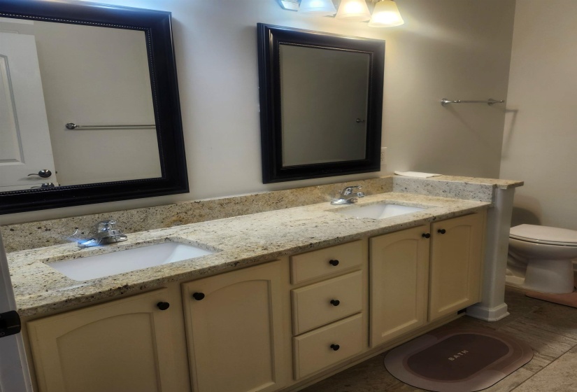Full bath with double vanity and toilet