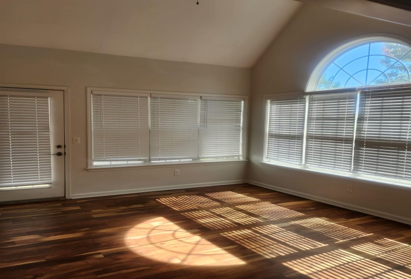 Unfurnished sunroom with vaulted ceiling
