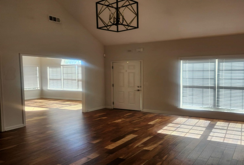 Foyer entrance with vaulted ceiling and dark wood finished floors