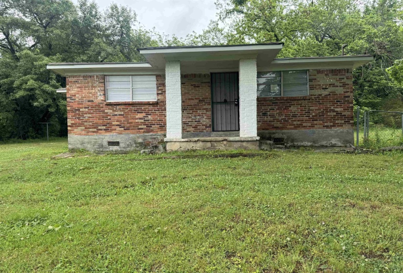 Brick exterior featuring a covered entry porch supported by a white column