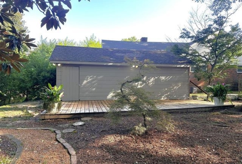 View of home's exterior featuring a deck and roof with shingles