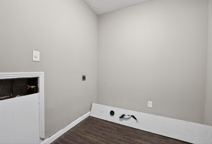 Laundry area featuring electric dryer hookup and dark wood finished floors