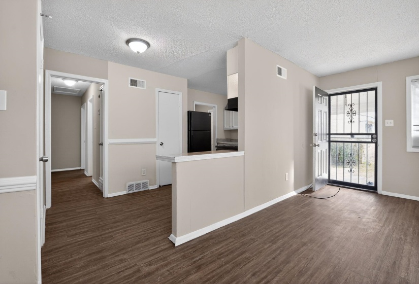 Foyer with dark wood-style flooring and a textured ceiling