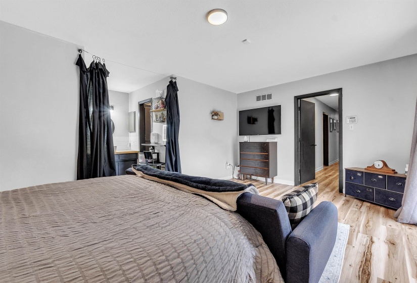 Bedroom featuring baseboards, visible vents, and light wood-type flooring