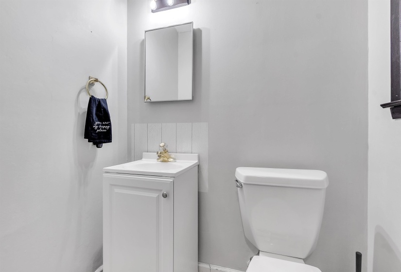Half bathroom featuring vanity and toilet