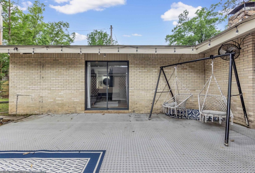 Property entrance featuring a patio area and brick siding
