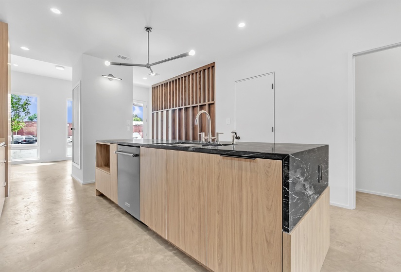Kitchen with modern cabinets, light brown cabinets, dishwasher, a sink, and recessed lighting
