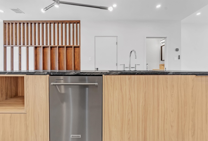Kitchen with stainless steel dishwasher, a sink, modern cabinets, recessed lighting, and light brown cabinets