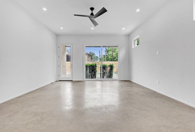 Spare room with recessed lighting, finished concrete floors, baseboards, and a ceiling fan