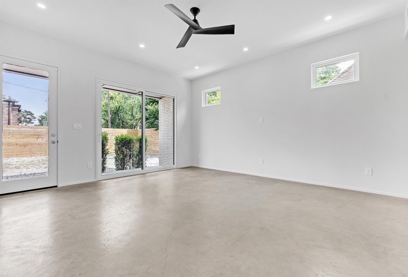 Empty room with recessed lighting, ceiling fan, baseboards, and finished concrete flooring