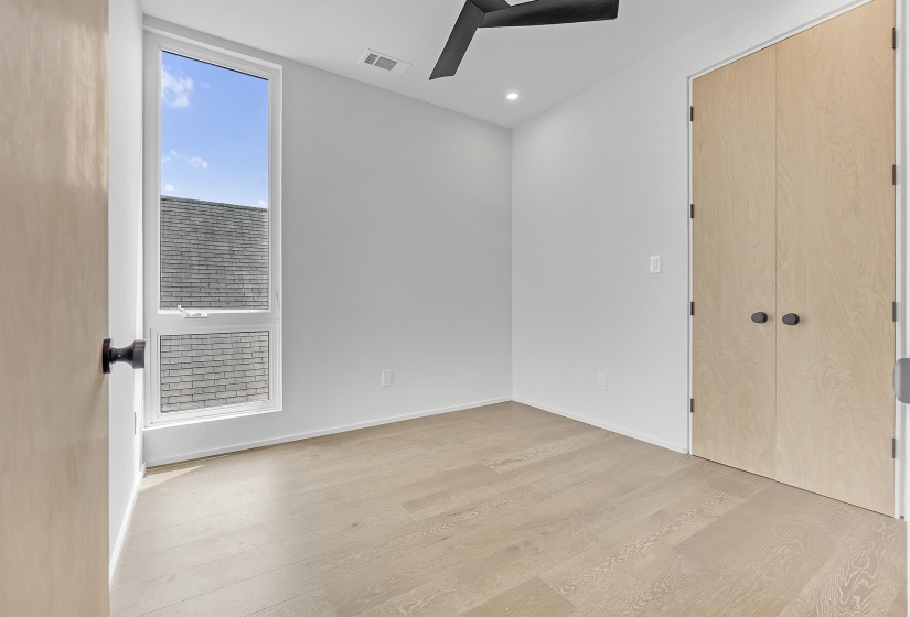 Spare room with light wood finished floors, baseboards, and recessed lighting