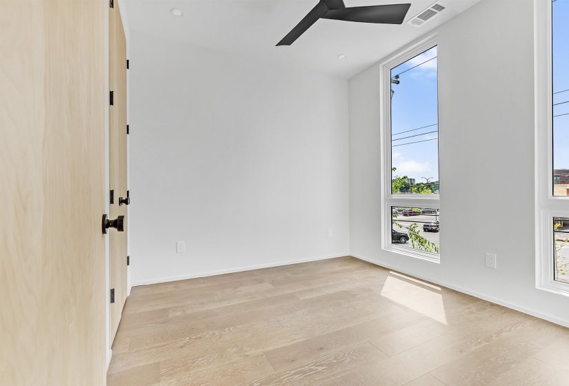 Unfurnished room featuring ceiling fan, light wood-type flooring, and baseboards