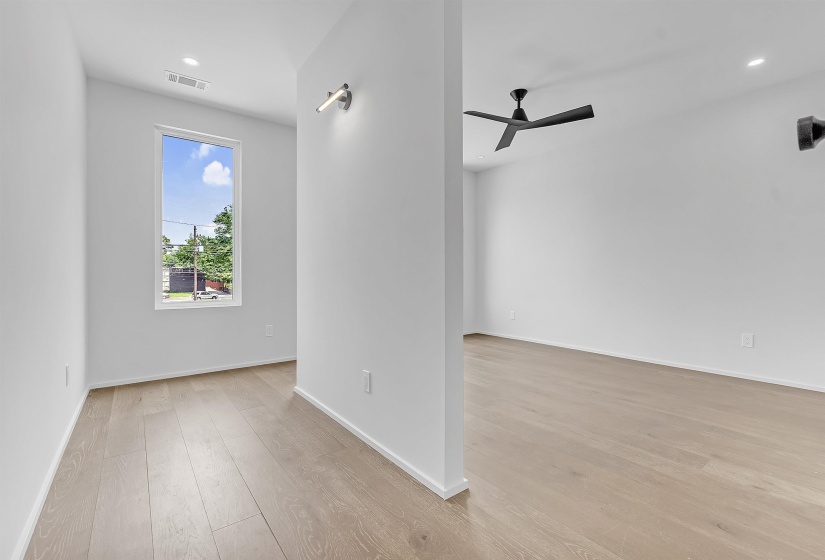 Unfurnished room with light wood finished floors, ceiling fan, baseboards, and recessed lighting