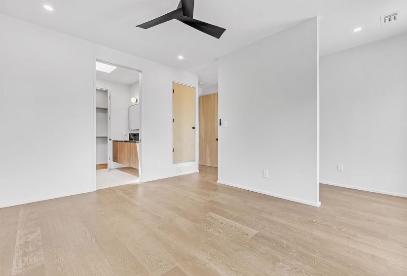Empty room with light wood-type flooring, ceiling fan, recessed lighting, and baseboards