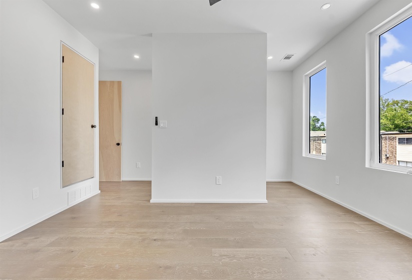 Empty room featuring light wood-style floors, recessed lighting, and baseboards