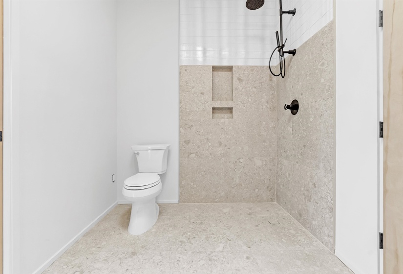 Bathroom with a tile shower and toilet