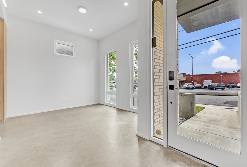 Doorway featuring finished concrete floors, recessed lighting, and baseboards