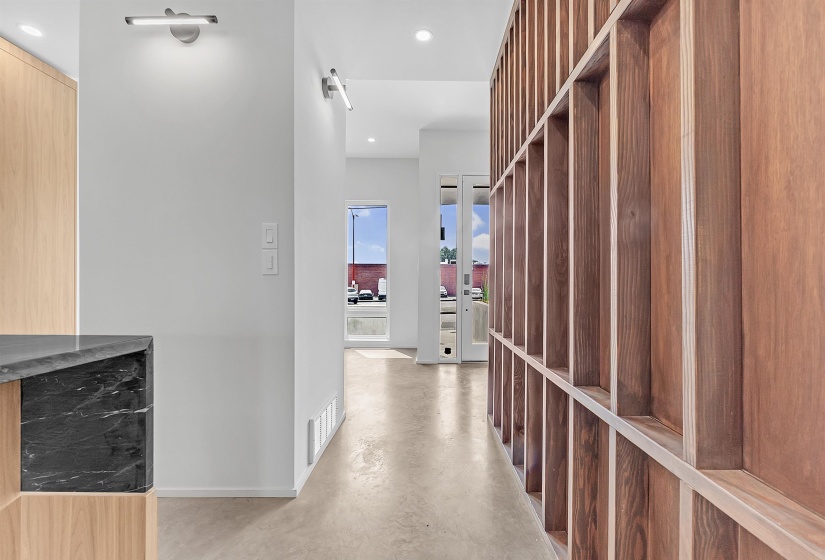 Corridor with concrete floors, recessed lighting, and baseboards