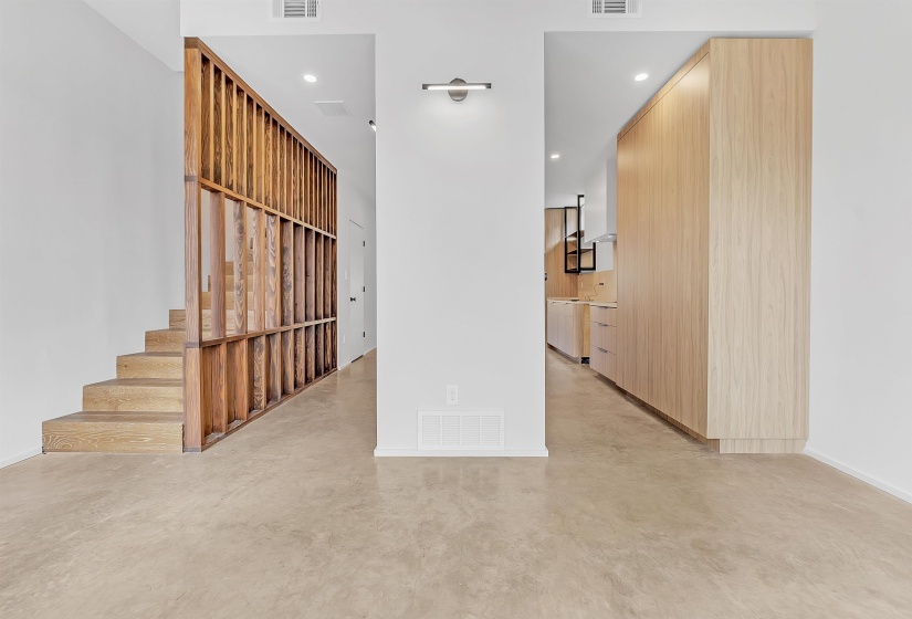 Stairway featuring finished concrete floors, baseboards, and recessed lighting