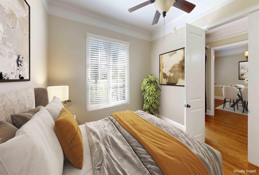 Bedroom featuring crown molding, wood finished floors, and ceiling fan