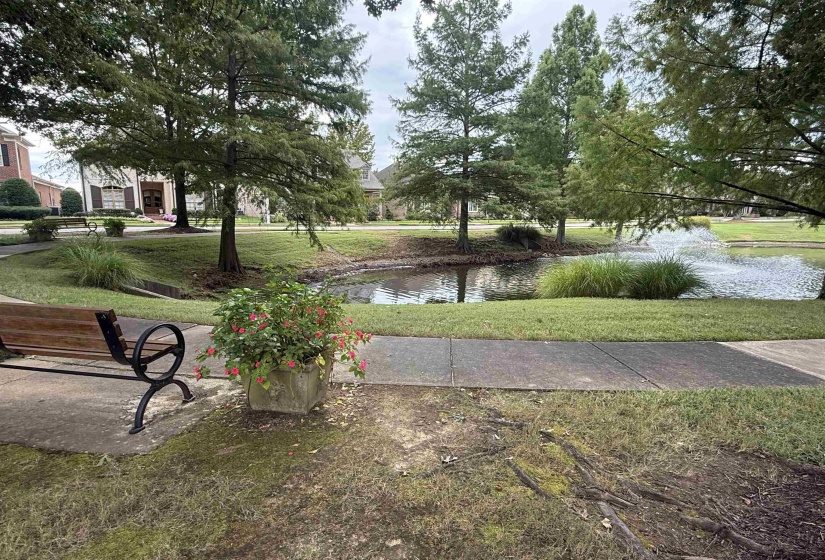 View of community with a yard and a water view