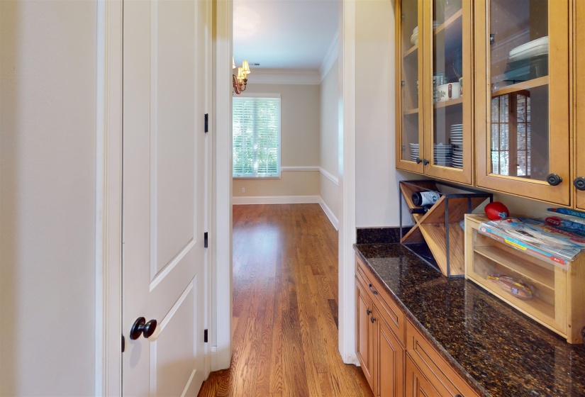 Corridor featuring ornamental molding and light wood-style floors