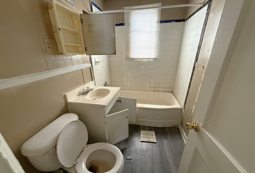 Bathroom featuring vanity, dark wood-style flooring, and shower / bathtub combination