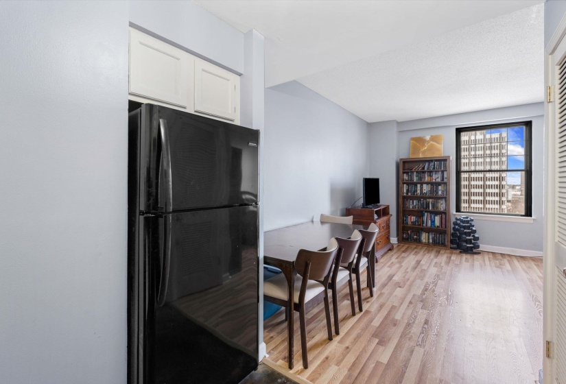 Kitchen featuring freestanding refrigerator, light wood-style flooring, and white cabinetry