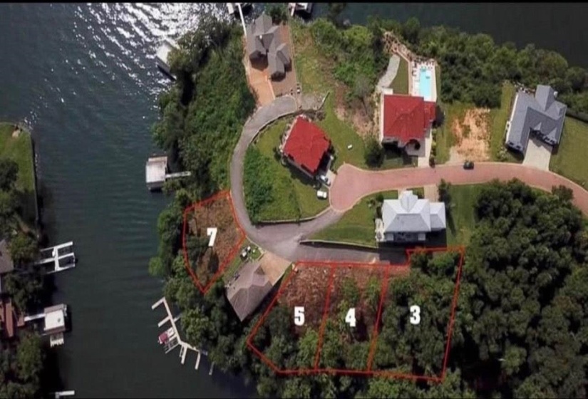 Aerial overview of property's location with a large body of water and property boundaries highlighted