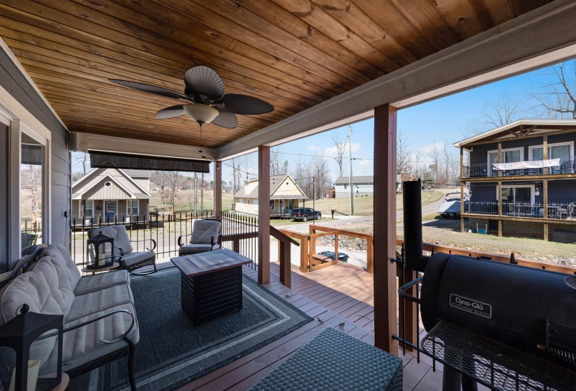 Wooden deck featuring a ceiling fan and area for grilling