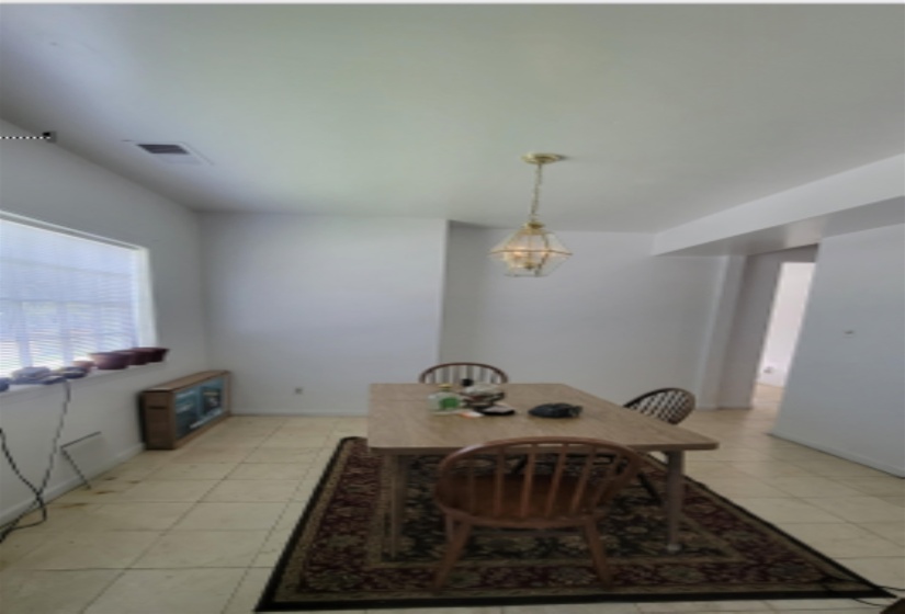 Dining space featuring light tile patterned floors