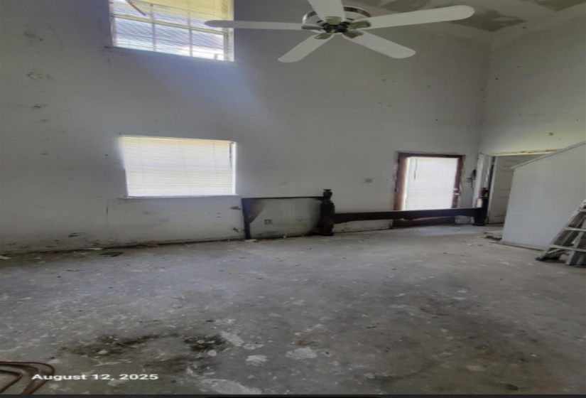 Empty room featuring a towering ceiling