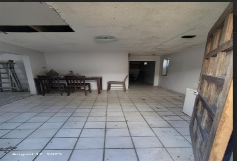Dining room featuring light tile patterned floors and a textured ceiling