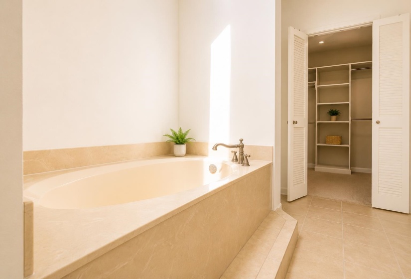 Soaking tub with a stone surround and bronze-finish fixtures