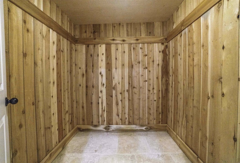 Unfurnished room featuring wood walls