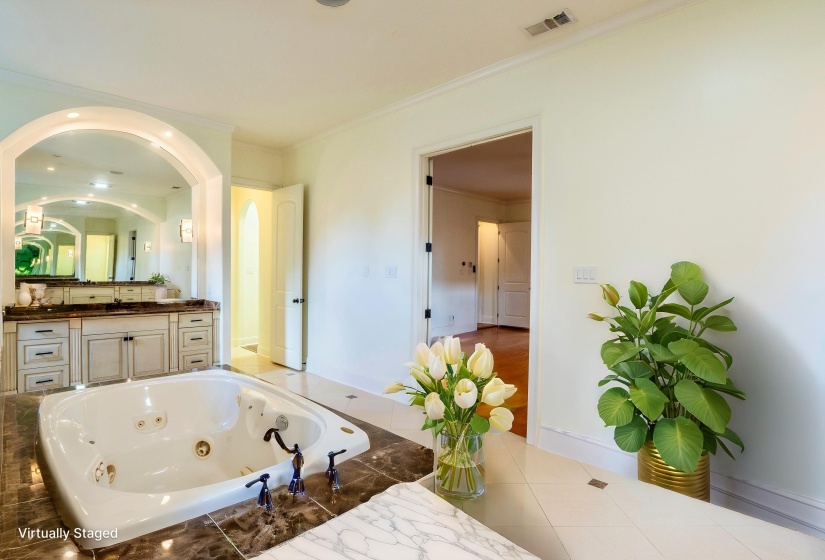 Full bath with tile patterned floors, vanity, a whirlpool tub, visible vents, and ornamental molding