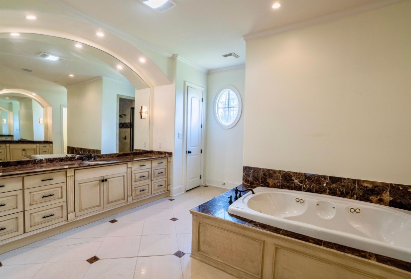 Bathroom featuring independent shower and bath, ornamental molding, tile patterned flooring, and vanity