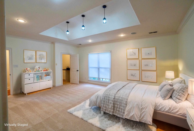 Bedroom featuring a skylight, baseboards, ornamental molding, recessed lighting, and light colored carpet