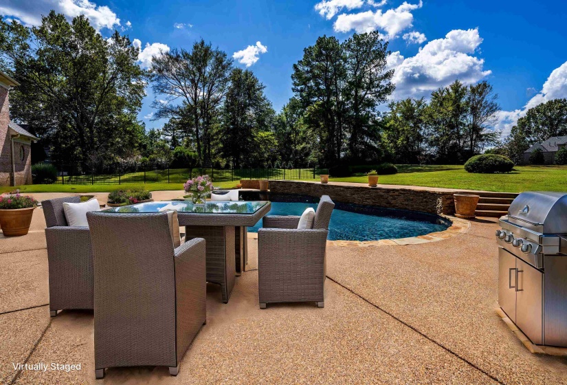 View of swimming pool featuring fence, area for grilling, a yard, and a patio area