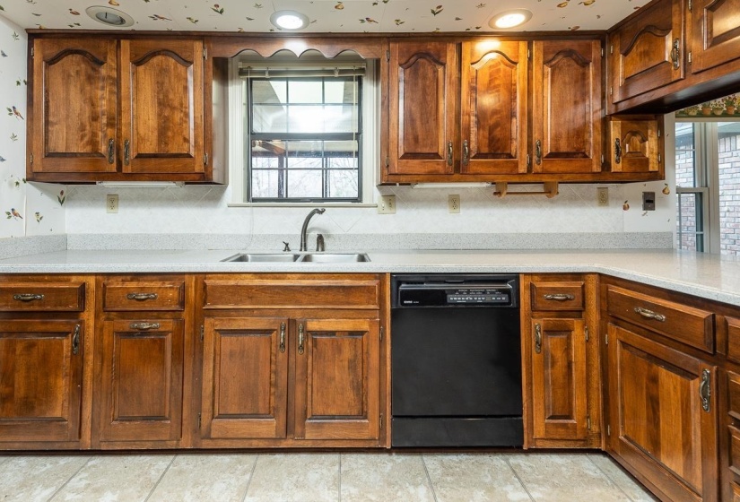 Kitchen with dishwasher and brown cabinetry
