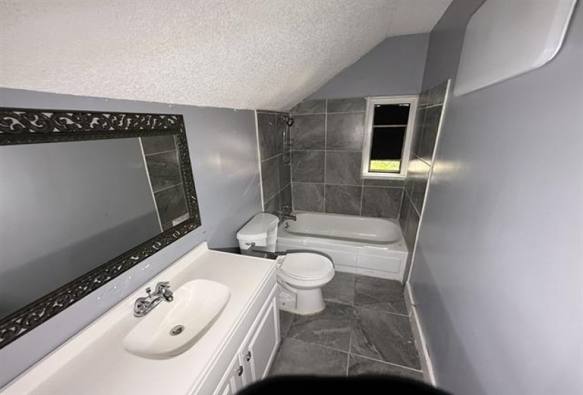 Bathroom with vanity and bathing tub / shower combination