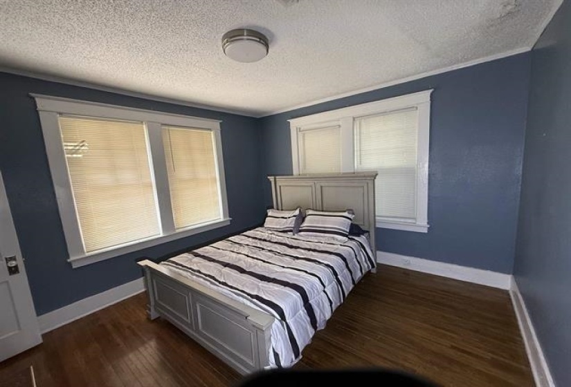 Bedroom featuring dark wood-style floors and a textured ceiling