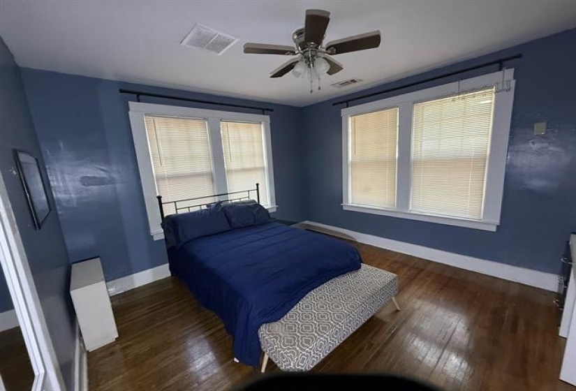 Bedroom featuring dark wood-style flooring and ceiling fan