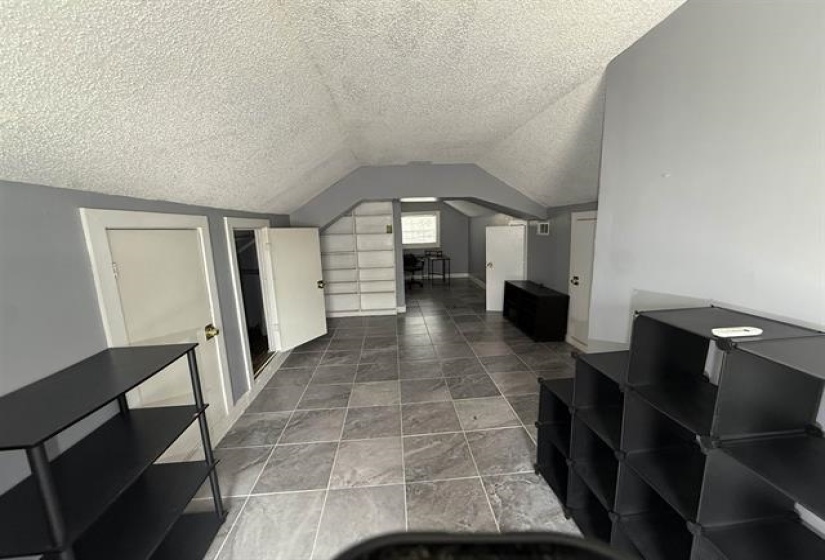 Bonus room with a textured ceiling