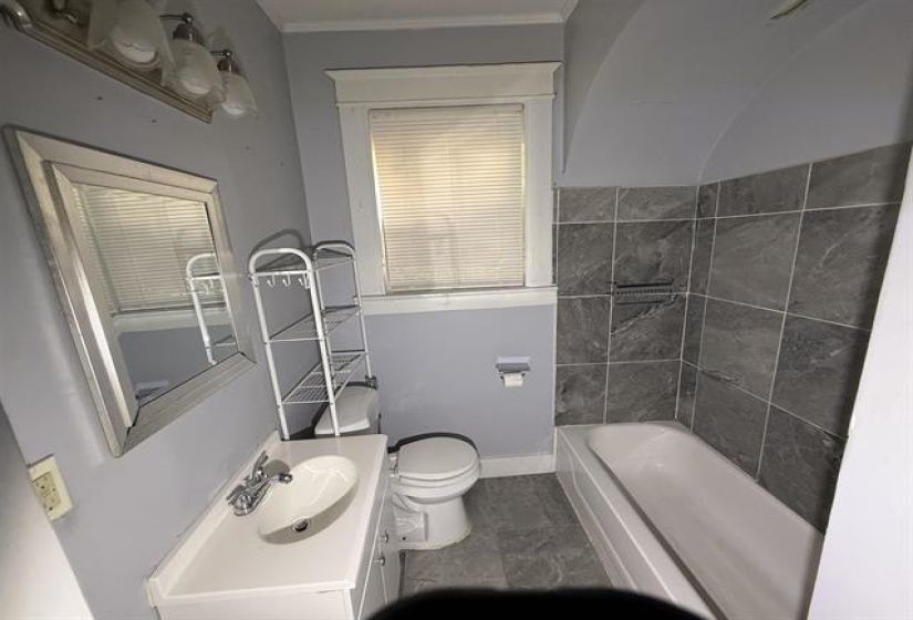 Bathroom with vanity and shower / washtub combination