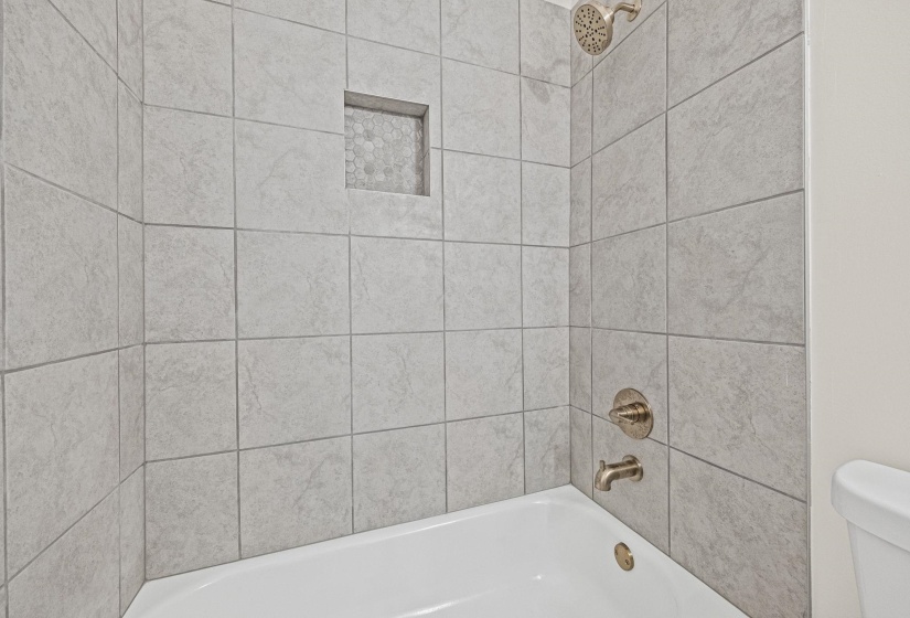 Full bathroom with washtub / shower combination and toilet