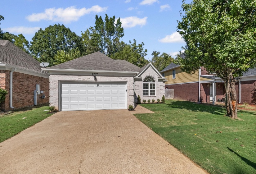 Single story home featuring brick siding, concrete driveway, roof with shingles, and an attached garage