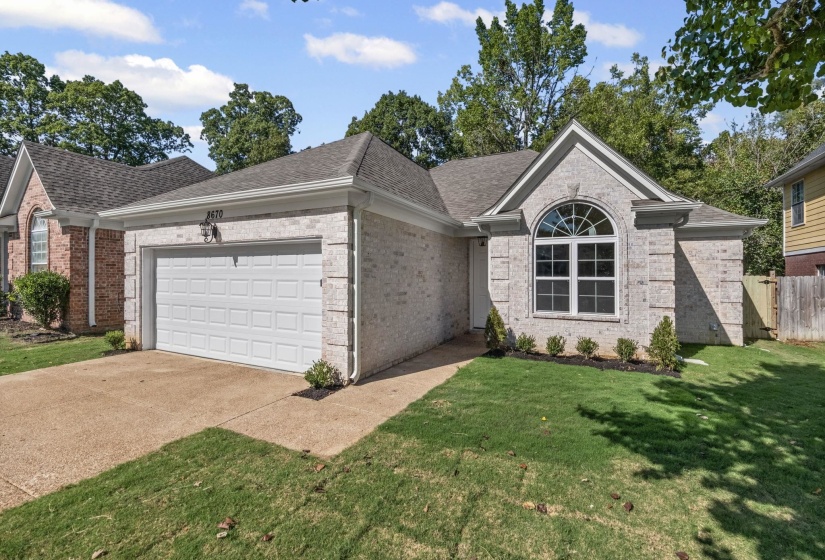 Ranch-style house featuring brick siding, roof with shingles, a garage, and concrete driveway