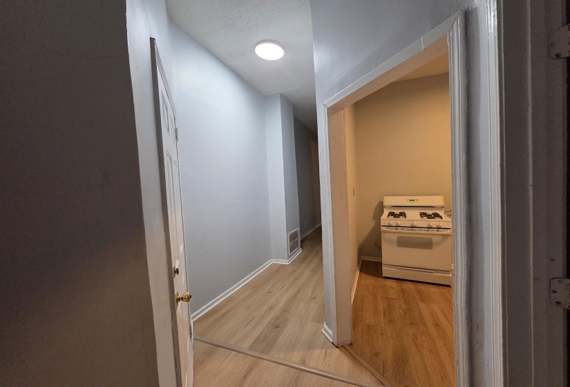 Hallway featuring light wood-style floors and baseboards